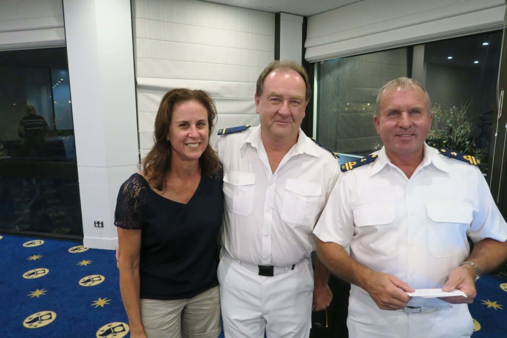 Two men in uniform standing next to a woman at Fremantle Sailing Club