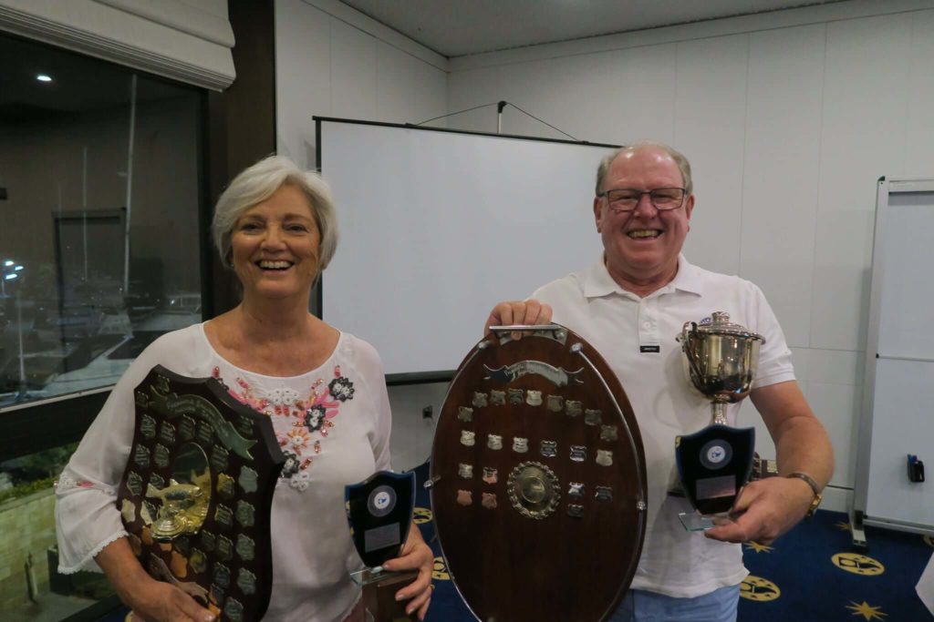 A man holding a trophy and shield and a women holding a trophy and shield at Fremantle Sailing Club