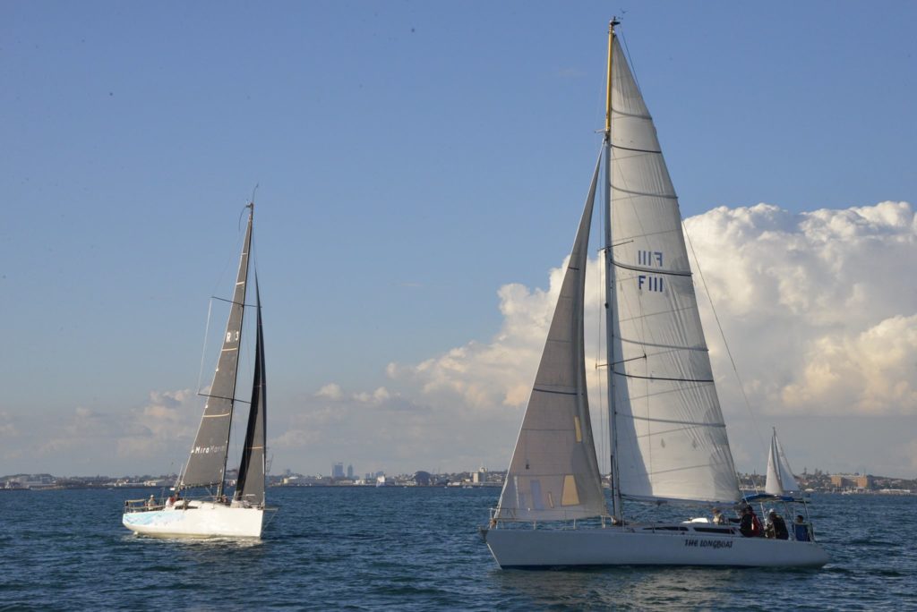 Two inshore sailing yachts on water